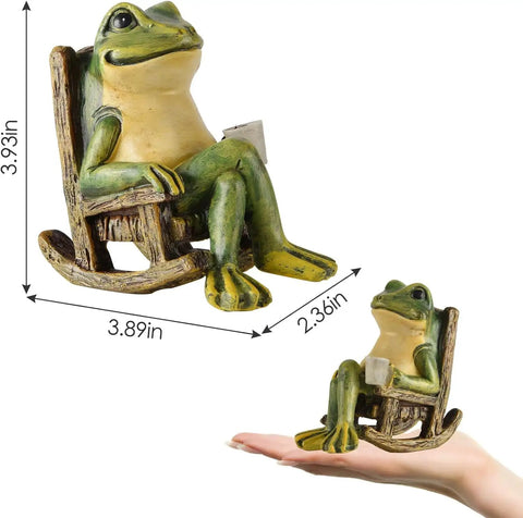 Mini Frog Garden Statue With Solar Lights, Cute Fairy Garden Decor, resin material, size 3.89 x 2.36 x 3.93 inches shown with hand for scale.