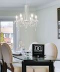Six Light White Crystal Candle Chandelier For Dining Room And Living Spaces Modern Farmhouse Glam Fixture With Clear Pendant Ornaments Prewired And Easy Install Perfect For Entryway And Foyer over a set dining table.