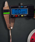 Digital caliper measuring thickness of Boss Hog Supreme Mesh Turbo 7 Inch Diamond Saw Blade 5/8 Inch Arbor Wet Or Dry Cut for Porcelain Tile.