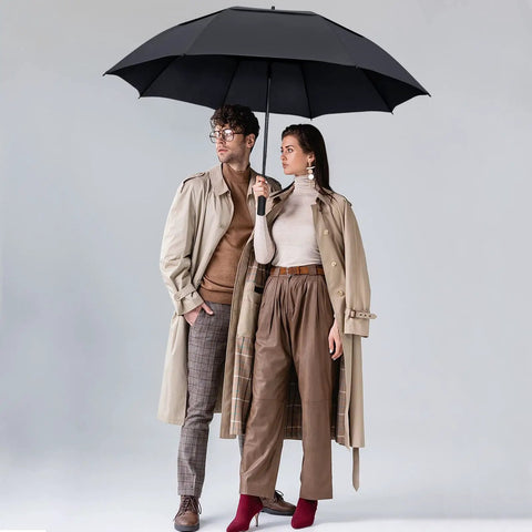 Oversized 54 Inch Windproof Golf Umbrella With Double Canopy held by two people in coats, showcasing rain protection, Black