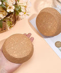 Two Pack Large Cork Stoppers For Bottles And Jars, 3.5 To 4.3 Inch Tapered Wood Cork Plugs shown on a table and in hand