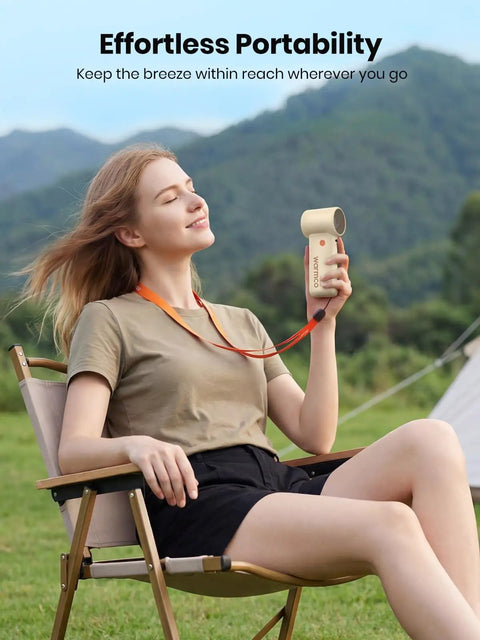 Person using 10000mAh Portable Handheld Fan With USB Rechargeable Power Dope Mini Turbo Breeze outdoors, enjoying cool air