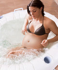 Pregnant woman in Home Water Birth Pool With Liner, Inflatable Labor Tub For Safe Labor At Home, 65 L x 55 W x 26 H, White PVC Birthing Pool For Labor