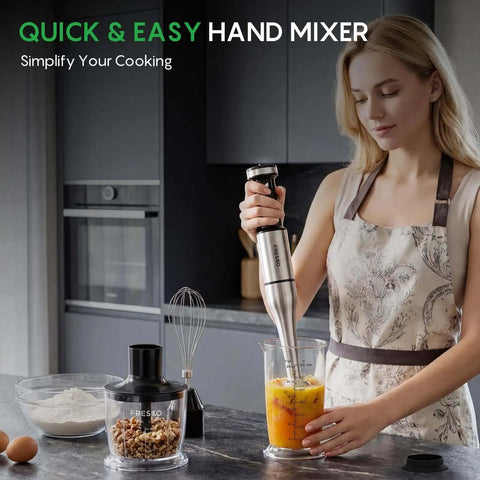 Top Tier Four In One Immersion Hand Blender With Variable Speed Trigger for blending fruits and nuts in a clear measuring cup.