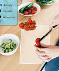 Heavy Duty Silicone Cabinet Door Bumpers, Ultra Grippy Self Adhesive Anticollision Tape, Pro Level Noise Dampening Pads For Kitchen Cabinets And Wood Furniture, Straight Up A Game Changer on a kitchen countertop with vegetables.