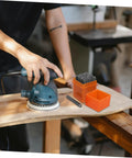 Person using a sander next to a 37 Piece Metal Stamping Kit With Letter And Number Punches Plus Heart Symbols for DIY projects.