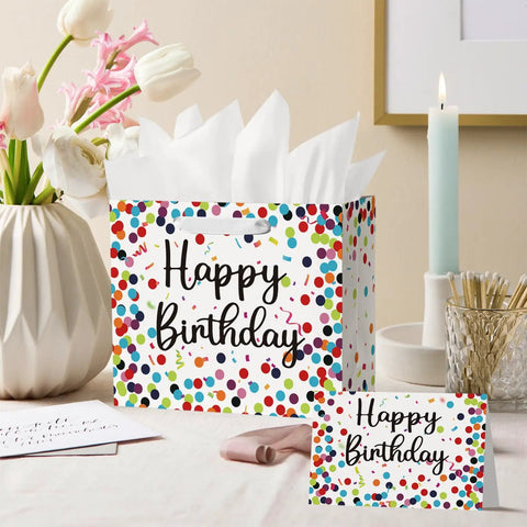 13 Inch Large Birthday Gift Bag With Tissue Paper And Card Happy Birthday Dots Streamers Gift Bag For Men Women Kids Eco Friendly Durable Gift Wrapping shown on table with flowers and candle