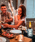 Glass Table Top Torches Four Pack Outdoor Citronella Torches With 12oz Fuel Capacity Refillable Wick And Cap Included next to people dining outdoors.