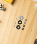 Universal Motorcycle Pedal Spacer Washers Quiets Engine Hum And Smashes Vibration set on wooden surface with tools.