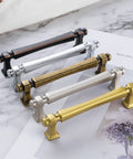 Assorted colored cabinet pulls displayed on a marble surface, showcasing 10 Pack 5 Inch Hole Centers Polished Chrome Cabinet Pulls