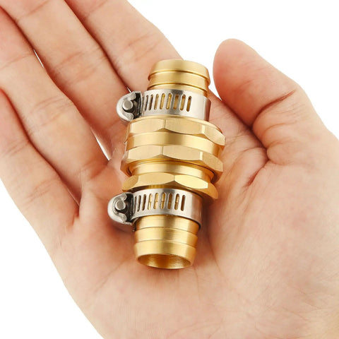 Close-up of Brass Garden Hose Repair Kit With Clamps For Three Quarter Inch Hoses in hand, showing metal connectors and clamps.
