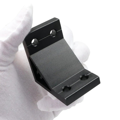 Close-up of a black 2040 aluminum extrusion corner bracket, part of a 14 Pack 2040 Aluminum Extrusion Corner Brackets 90 Degree Right Angle L Connectors With T Slot Nuts And Bolts For 2040 20 40 Extruded Aluminum Profile Build Kit, held by a gloved hand.