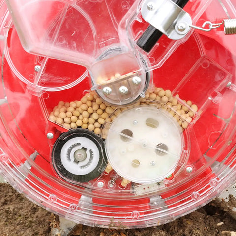 Manual Seeder For Garden Use, Metal Precision Push Seeder With Clear Seed Storage Box, soil beneath visible seeds