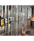 Three Beam Line Laser With Self Leveling And Magnetic Pivot Bracket, 2x Brighter Diodes For Superior On Site Visibility, Delivers Precise 90 Degree Layout On Metal Surfaces, Pro Grade Framing, Cabinetry And Installations DW089K in use on metal studs at a construction site.
