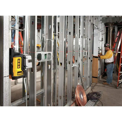 Three Beam Line Laser With Self Leveling And Magnetic Pivot Bracket, 2x Brighter Diodes For Superior On Site Visibility, Delivers Precise 90 Degree Layout On Metal Surfaces, Pro Grade Framing, Cabinetry And Installations DW089K in use on metal studs at a construction site.