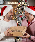 Two men in holiday attire exchanging a 3D Dragon Ship Wooden Puzzle Kit For Adults, 352-Piece Brain Teaser Hobby Model Building Set box.