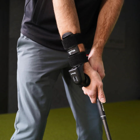 Golfer using Wrist-X Golf Swing Training Aid with Audible Click Feedback, Adjustable 0 To 70 Degrees, Wrist Hinge Trainer on right wrist