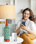 Vintage Ceramic Table Lamps Set Of 2 For Your Living Room And Bedroom Teal MCM Style Nightstand Lamps With USB Port 3 Way Dimmable Oatmeal Linen Shade Bulb Included next to a smiling woman using a phone.