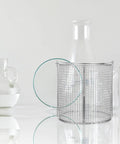 Heavy Duty Stainless Steel Parts Cleaning Basket With Sure Grip Swinging Handle For Ultrasonic Dip And Drain Runs Round Design on lab table.