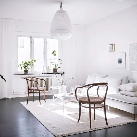 Modern living room with 15.7In By 16.4Ft Matte White Peel And Stick Wallpaper, featuring white walls and minimalist decor.