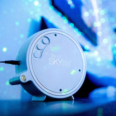 Sky Lite LED Laser Star Projector with green stars and blue nebula for gaming rooms and home theaters, close-up view