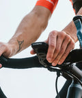 Cyclist mounting GPS Bike Computer With Wireless Cadence And Power Sensor Support 2.6 Inch Auto Backlight Display on handlebars.