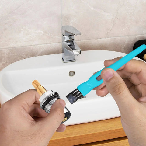 Applying Food Grade Silicone Lubricating Plumber Grease For Waterproof Faucets And O Rings with brush near bathroom faucet
