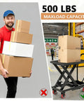 Person carrying boxes with 500 Lb max load capacity next to Built Tough Hydraulic Lift Table Cart in warehouse.