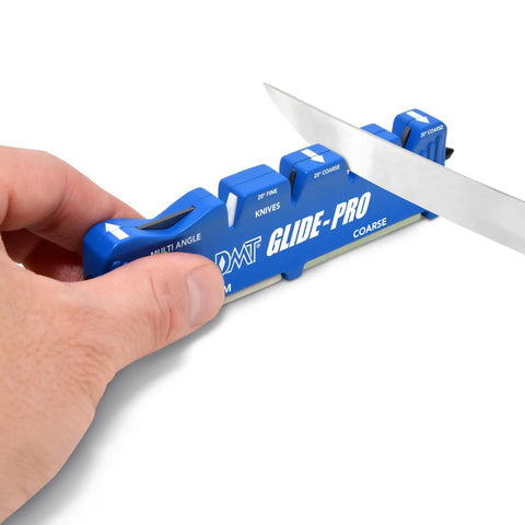 Person using Glide-Pro All-In-One Multi Tool Blade Sharpener With Coarse And Fine Ceramic Pull-Through Stones on knife blade