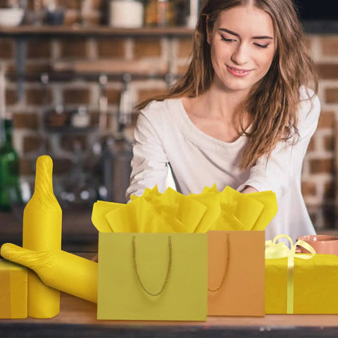 Woman arranging Bright Yellow Tissue Paper Sheets 20 By 14 Inches Pack of 100 For Gift Bags Wrapping Paper DIY Crafts Party Decor