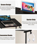 Total Game Changer Small Height Adjustable Standing Desk With Tiltable Tabletop And Smooth Rolling Wheels featuring groove design for devices.