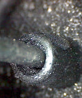 Graphite Dry Lube for Wood Derby Cars with Tungsten Moly Boron Blend applied to axle, showing micro lubrication on wheel contact.