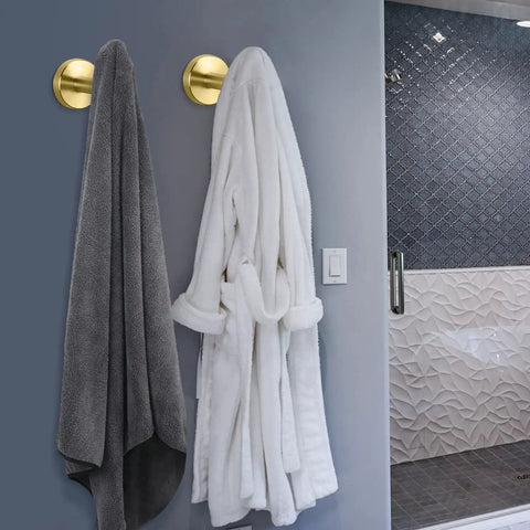 Beefy Heavy Duty Wall Mounted Brushed Gold Stainless Steel Coat Hooks And Towel Hooks Set Four Pack For Bathroom Kitchen Garage Living Room Hotel Rustproof 304 Stainless Steel Robe Hanger Holder in use with bathrobe and towel hanging.