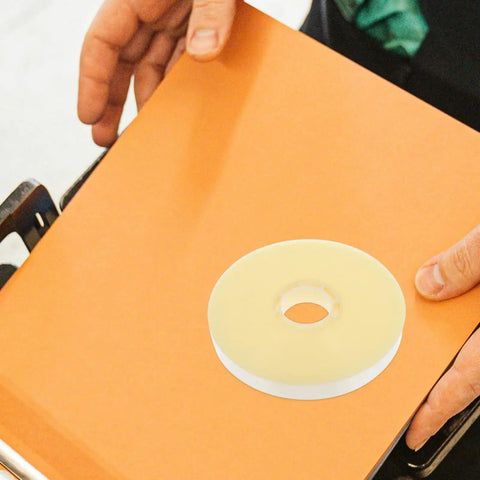 Heavy Duty Strapping Tie For Machines And Box Packaging Pro Grade Fast Easy Packing Tape For Shipping on orange surface