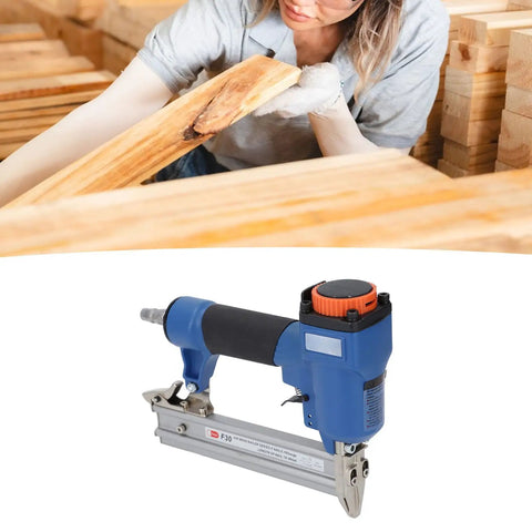 Heavy Duty Pneumatic Stapler With 100 Nail Capacity Ergonomic Soft Grip Air Powered Finish Nailer close-up on woodwork.