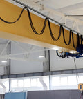 Four Wheel Cable Trolley System installed on a strut channel in a warehouse, showcasing smooth operation for safe lifting.
