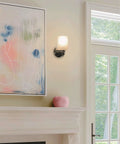 Kira Home Phoebe 8" Modern Industrial Wall Sconce for Bathroom Vanity, Pack of 2, mounted on a light wall with artwork.