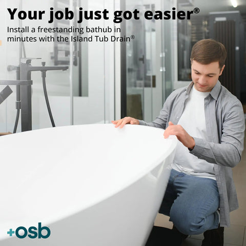 Man installing tub with Two Piece ABS Freestanding Tub Drain Kit And Rough In With No Fuss Install in bathroom.