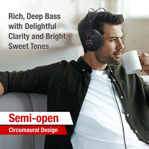 Man wearing Semi Open Over Ear Studio Headphones With 50mm Neodymium Drivers Wired For Monitoring Mixing And Music, sipping coffee