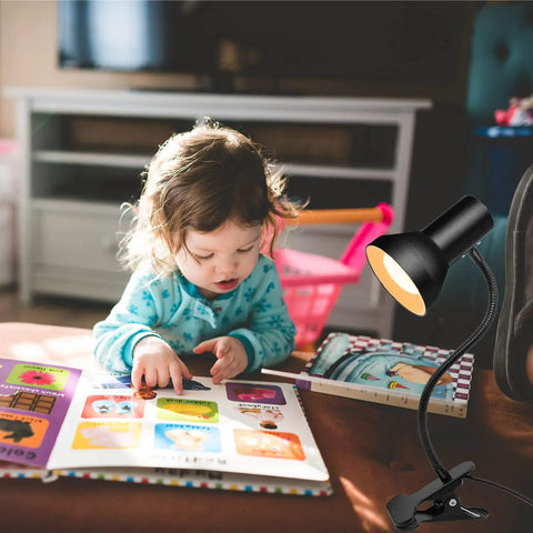 Eye Care Desk Lamp With 360 Degree Gooseneck Clip On Light For Desk Bedside Or Office next to child reading a book