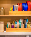 Bamboo Kitchen Lids Organizer With Adjustable Dividers for Food Storage Containers up to 9.5 Inches arranged in a kitchen cabinet