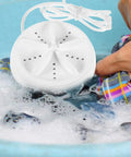 Travel Ready Compact Washing Machine Acts As A Laundry Game Changer By Delivering A Gentle Hand Feel Wash For Underwear Delicates And Light Fabrics Quick Spin Dry Keeps Road Trips Stress Free, portable washer in soapy water.