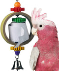 Tape Dispenser Bird Toy With Cardboard Bagel And Machine Paper, Chewable Shredding Components, Sensory Bell, Perfect For African Grey Parrots And Cockatoos, Large Bird Size 14x5 Inches, High Energy Mental Stimulation And Fun. Pink cockatoo beside hanging shred toy with paper roll and bell