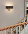 Sleek Mid Century Modern 16 Inch Two Light Wall Sconce In Cool Brass Gold Finish With Black Fabric Shade in hallway