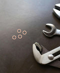 Copper Sealing Washers Kit 0.4 Inch Diameter 40 Pcs displayed with tools on black surface.