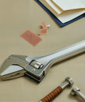 20 Piece Drawer Glide Stopper Set for Tables and Dressers, brown plastic tack-in slider with tools on beige surface
