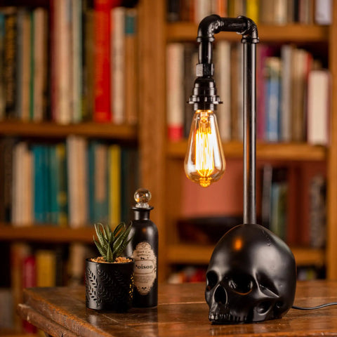 Black Industrial Skull Lamp With Skeleton Decor For Gothic Bedroom Dope Handcrafted Cast Iron And Resin Skull Table Lamp Vintage Industrial Vibe UL Certified 18.5 Inches Tall 1 to 40W Bulb Not Included on wooden table