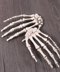 Six Pack Halloween Skeleton Hands Set Realistic Plastic Skeleton Hands for Spooky Decor Right and Left Hands on wood surface