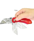 Amazon Basics red aluminum folding utility knife with back-lock, blade extended in hand.