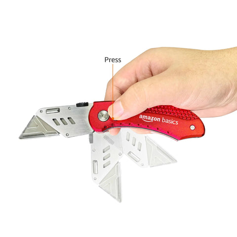 Amazon Basics red aluminum folding utility knife with back-lock, blade extended in hand.